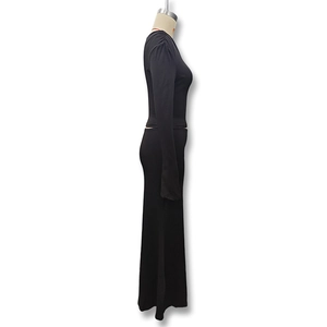 Detail view of the sleek black long sleeve top and maxi skirt set with draped fabric