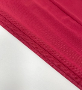 Close-up of red mesh fabric detailing breathable honeycomb texture on dress