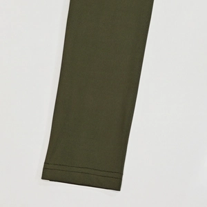 Detailed view of the olive green flared jumpsuit sleeve with durable twin-needle stitching