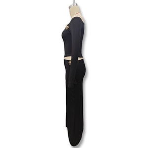 Detailed side view of black knit skirt set with golden metal floral accents on waist