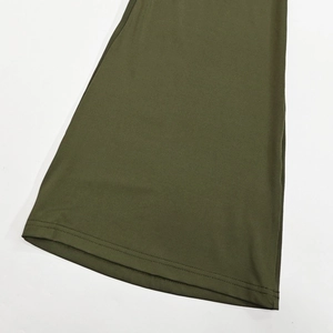 Detail of the olive green wide-leg pants showing premium double-stitched hem finish