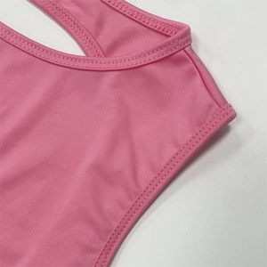Detailed close-up of pink knit fabric straps and neckline stitching for two-piece set
