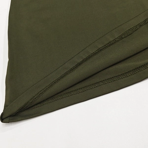 Detail shot of the hem showing durable double-needle stitching on green fabric