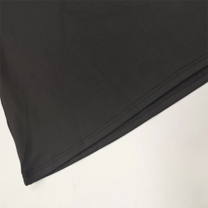 Close-up of the double-needle stitched hem on high-quality black knit fabric