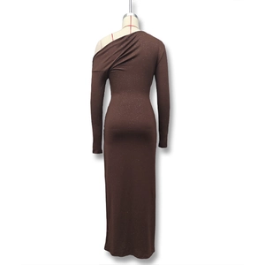 Macro shot of dark brown ruched fabric with sparkling silver glitter on slim fit dress
