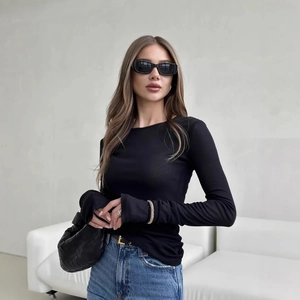 Slim fit black long sleeve crew neck top paired with casual jeans for a chic look