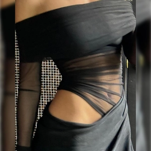 Detail of off-shoulder dress with sheer mesh patchwork and side waist cut-out design
