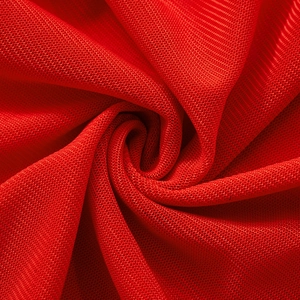Close-up of red mesh fabric with breathable honeycomb texture and elastic knit structure