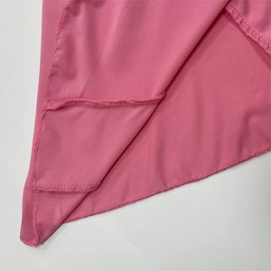 Macro detail of pink knit fabric showing precision stitching and texture of the set
