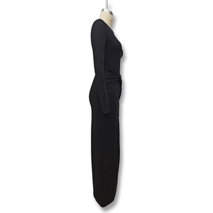 Detail view of the gathered knot waist and shimmering glitter fabric on black maxi dress