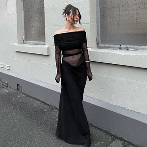 Detail of elegant black off-shoulder maxi dress with sheer mesh cutouts and long sleeves