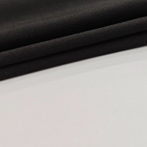 Close-up of premium black high-density knitted fabric showing soft texture and fine grain