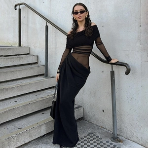 Detail of off-shoulder black maxi dress with mesh panels and ribbed waist features