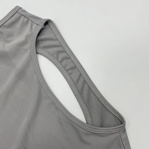 Close-up of grey knitted fabric details with professional double-needle flat stitching