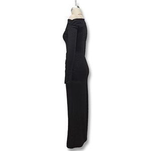 Detail of elegant black off-shoulder maxi dress with sparkling glitter knit fabric texture