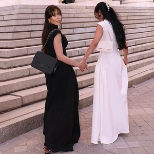 Detail of elegant black and white sleeveless maxi dresses with a chic A-line silhouette