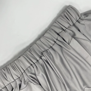 Detail of the elastic waistband on gray ribbed fabric with a soft vertical texture