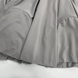 Close-up of the grey hemline detail showing high-quality stitching and smooth fabric texture