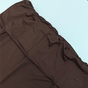 Close-up detail of dark brown knitted dress showing high-quality elastic fabric and waistband