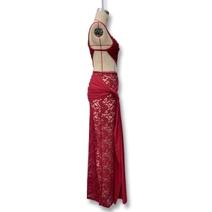 Detail of red floral lace evening dress featuring side cut-out design and flowy streamers