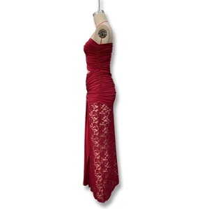 Detail of burgundy evening dress featuring elegant ruching and side lace cutout panels