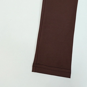 Close-up of the dark brown dress sleeve featuring durable double-stitched reinforced hem detail