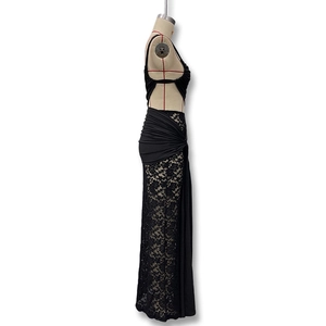 Detailed close-up of floral lace fabric and sexy side waist cutout on black midi dress