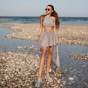 Women two-piece gray resort set with backless crop top and pleated mini skirt