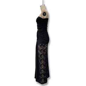 Detailed side view of black lace patchwork and ruching texture on elegant evening dress