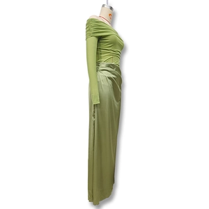 Detail of off-shoulder green dress with sheer mesh texture and satin skirt splice