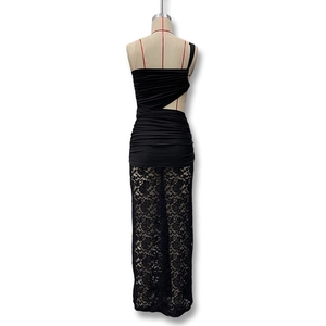 Back view of black lace dress showing pleated fabric, waist cutout and sheer floral lace