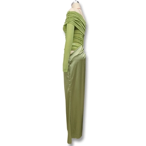 Detail view of green off-shoulder pleated top and matching satin maxi skirt on mannequin