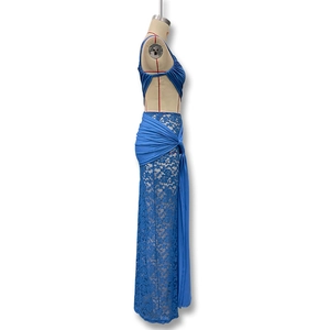 Detail of blue lace maxi skirt featuring waist wrap design and flowing ribbon decoration
