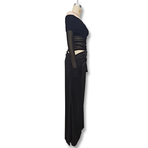 Detail of black off-shoulder mesh dress featuring waist cutout and draped ruching texture