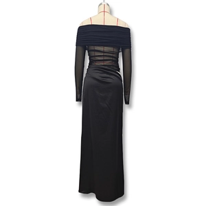 Detail of off-shoulder evening dress featuring sheer mesh sleeves and ruched waist textures