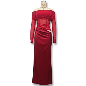 Detailed view of red off-shoulder gown with mesh patchwork sleeves and ruched waist detail