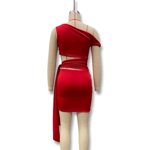 Detail view of red one-shoulder dress featuring waist cut-out and tie-up design