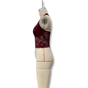 Détail d'une brassière en dentelle bordeaux avec crochet floral et bord festonné