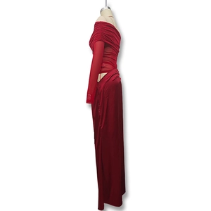 Detail of red off-shoulder long-sleeved dress with mesh patchwork and ruched satin texture