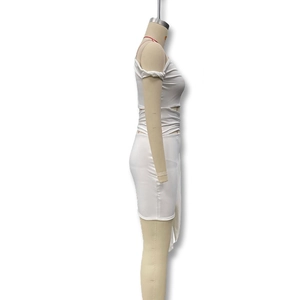 Detail of white slim dress showing side cut-outs and twisted knot design on stretch fabric