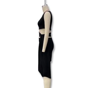 Detail of black two-piece set featuring side lace-up ties and side slit on the skirt