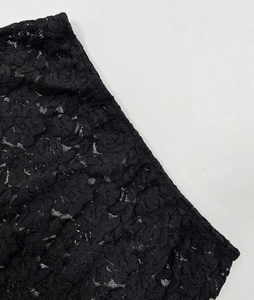 Detail shot of the elegant black floral lace pattern with intricate hollow-out texture