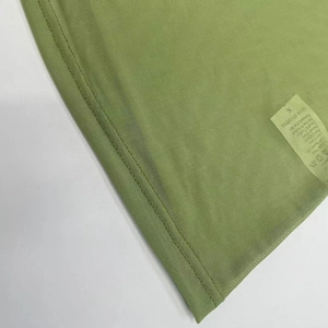 Detail view of olive green mesh dress showing high-quality double stitching and fine texture