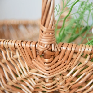 Detail of hand-woven wicker basket showing tight natural wood fiber patterns and sturdy handle