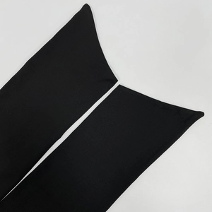 Detailed macro view of high-quality black knitted fabric with seamless edge finishing