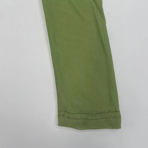 Detailed macro shot of bright green mesh fabric with professional double-needle stitching