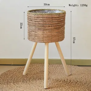 Detail of woven rattan plant stand with dimensions 30cm diameter and 57cm height