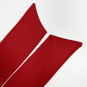 Detailed close-up of vibrant red elastic knit fabric with high-density ribbed texture