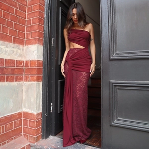 Detail of burgundy lace stitching and asymmetrical waist cutout on an elegant dress