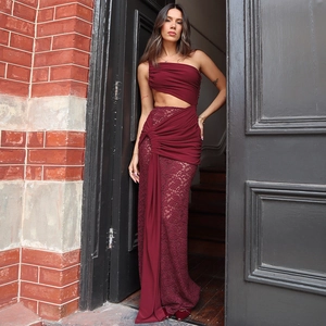 Detail of burgundy lace dress featuring chic one-shoulder cutout and elegant pleats